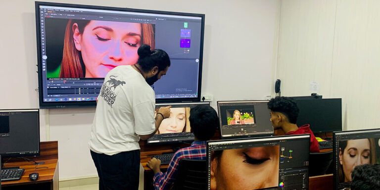 An instructor guiding a student through a shot at their workstation